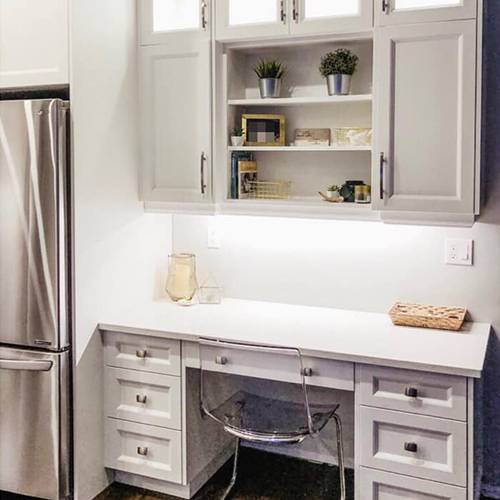 Customized white room table with drawers and over-head cabinets